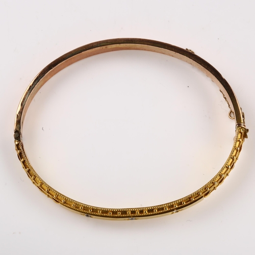 1177 - A Victorian Etruscan style diamond hinged bangle, star set with old-cut diamonds in unmarked gold se... 