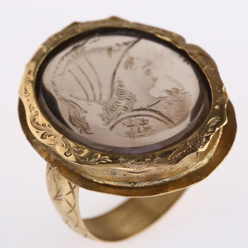 1179 - A 19th century smoky quartz Minerva intaglio seal ring, unmarked gold foliate engraved settings, wit... 