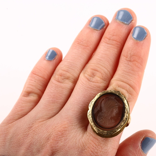 1179 - A 19th century smoky quartz Minerva intaglio seal ring, unmarked gold foliate engraved settings, wit... 