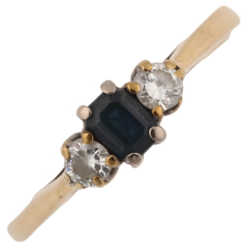 1218 - A modern 9ct gold three stone sapphire and diamond ring, set with emerald-cut sapphire and modern ro... 