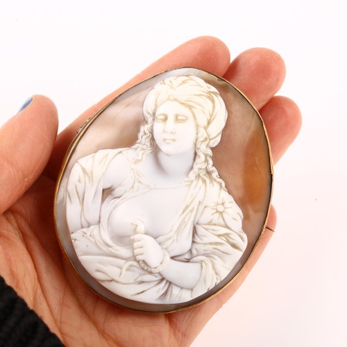 1216 - A large 19th century shell cameo brooch, relief carved depicting the death of Cleopatra, in unmarked... 