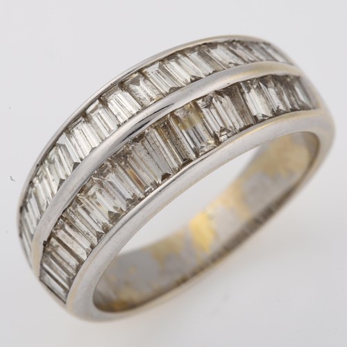 1222 - A modern 18ct white gold diamond band ring, ridge set with baguette-cut diamonds, total diamond cont... 