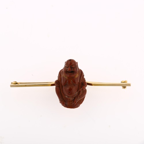 1226 - A Chinese carved olive nut Budai bar brooch, unmarked gold curved settings, brooch length 56.6mm, 5g