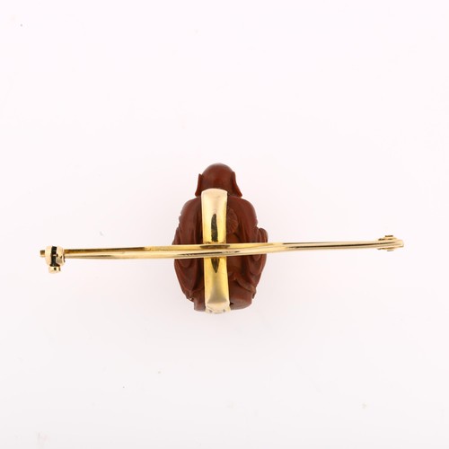 1226 - A Chinese carved olive nut Budai bar brooch, unmarked gold curved settings, brooch length 56.6mm, 5g