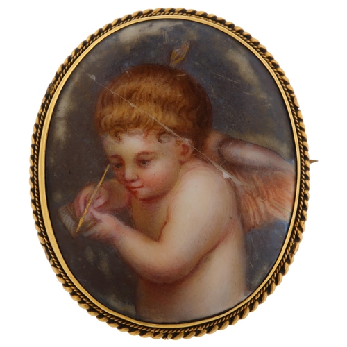 1247 - A 19th century miniature porcelain brooch, hand painted panel depicting cherub, in unmarked yellow m... 