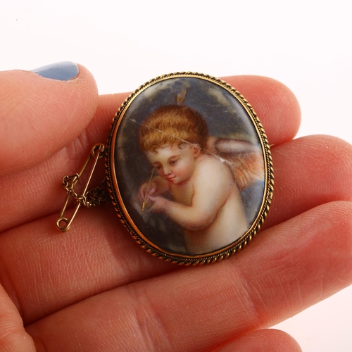 1247 - A 19th century miniature porcelain brooch, hand painted panel depicting cherub, in unmarked yellow m... 