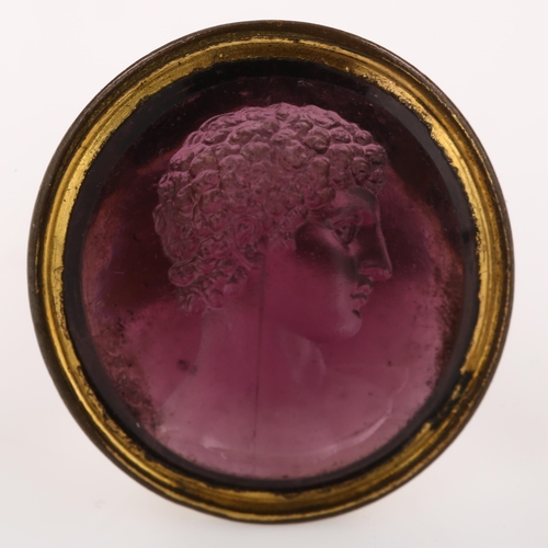 1251 - After Edward Burch (1730 - 1814), a Georgian amethyst paste intaglio seal fob, impressed with male h... 