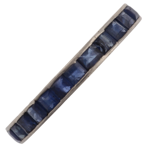 1276 - A sapphire full eternity ring, unmarked white metal settings, set with calibre-cut sapphires, band w... 