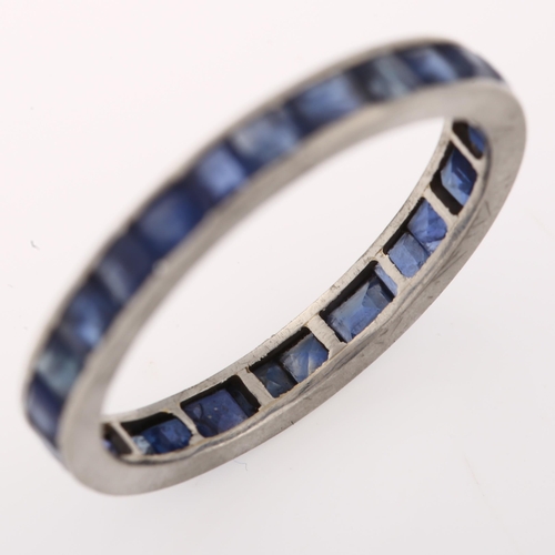 1276 - A sapphire full eternity ring, unmarked white metal settings, set with calibre-cut sapphires, band w... 