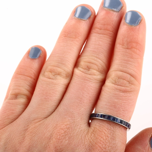 1276 - A sapphire full eternity ring, unmarked white metal settings, set with calibre-cut sapphires, band w... 