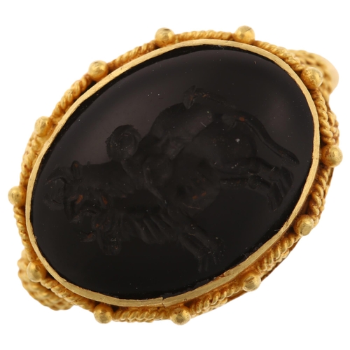 1278 - A Victorian style seal ring, unmarked yellow metal settings with wirework surround and intaglio carv... 