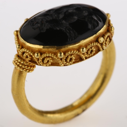 1278 - A Victorian style seal ring, unmarked yellow metal settings with wirework surround and intaglio carv... 