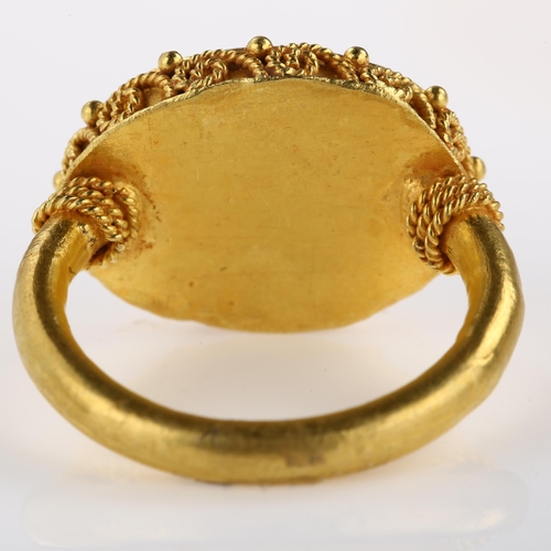 1278 - A Victorian style seal ring, unmarked yellow metal settings with wirework surround and intaglio carv... 