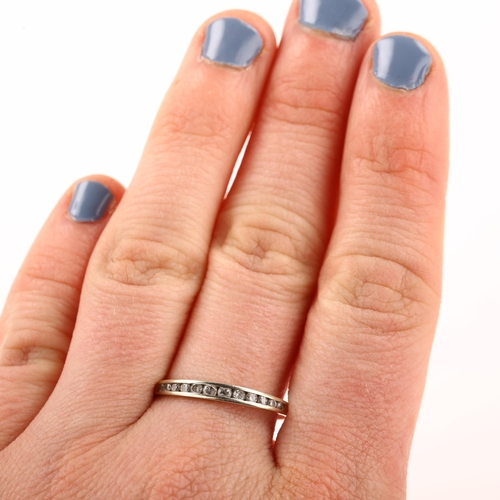 1292 - A modern 9ct white gold diamond half eternity ring, channel set with modern round brilliant-cut diam... 