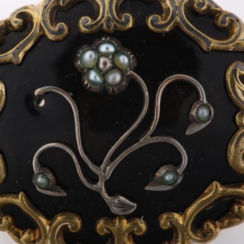 1301 - A Victorian split pearl and black enamel floral mourning brooch, unmarked gilt-metal settings with o... 