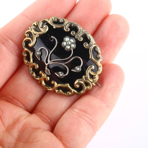 1301 - A Victorian split pearl and black enamel floral mourning brooch, unmarked gilt-metal settings with o... 