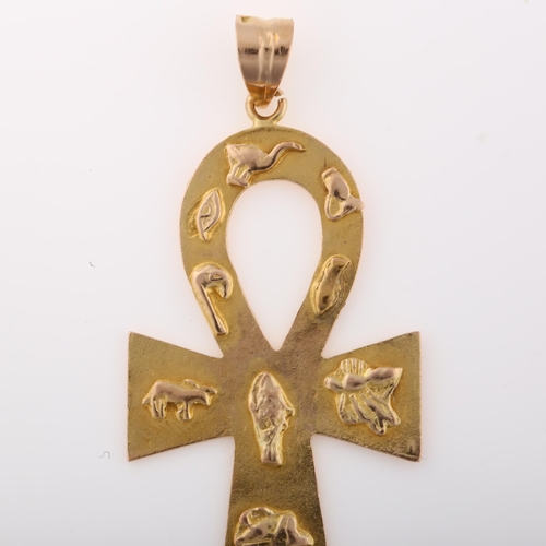 1307 - A large Egyptian Ankh cross pendant, unmarked gold settings with relief hieroglyphs, pendant height ... 