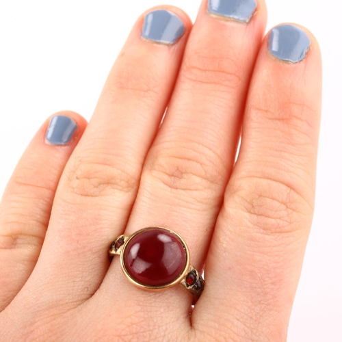 1312 - An Antique garnet dress ring, unmarked gold closed-back settings with round cabochon garnet, setting... 