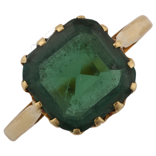 1313 - A solitaire green tourmaline dress ring, unmarked gold settings with octagonal step-cut tourmaline, ... 