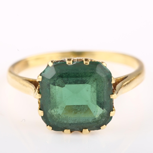 1313 - A solitaire green tourmaline dress ring, unmarked gold settings with octagonal step-cut tourmaline, ... 