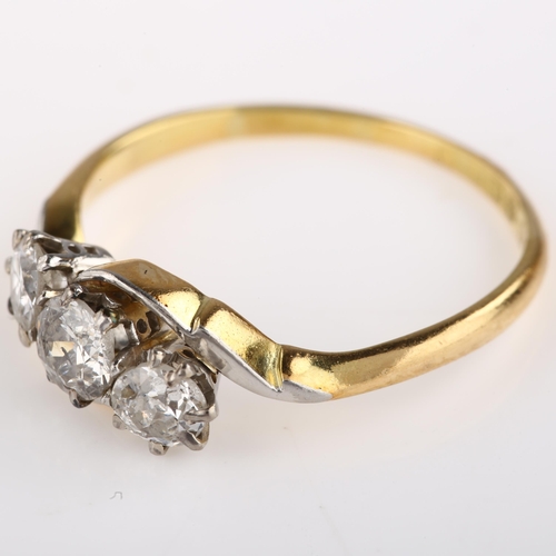 1314 - An early 20th century 18ct gold three stone diamond crossover ring, set with old European-cut diamon... 