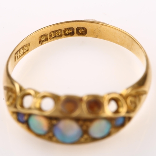 1317 - An early 20th century 18ct gold graduated five stone opal half hoop ring, set with round cabochon op... 