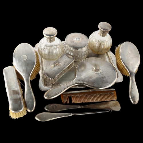 1539 - An Art Deco George V silver 12-piece dressing table set, including tray, hand mirror, hair brushes, ... 