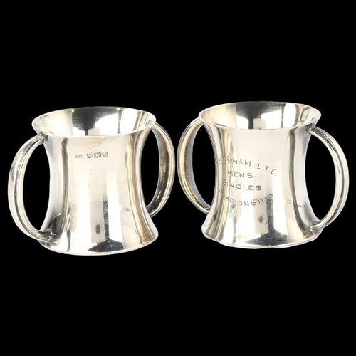 1545 - A pair of George V miniature silver 2-handled measure trophy cups, hour glass form with gilt interio... 