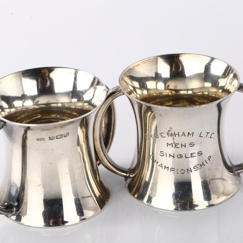 1545 - A pair of George V miniature silver 2-handled measure trophy cups, hour glass form with gilt interio... 