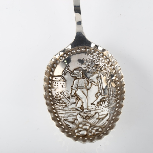 1548 - A large Dutch silver serving spoon, with relief embossed farmer bowl and bear handle, circa 1900, le... 