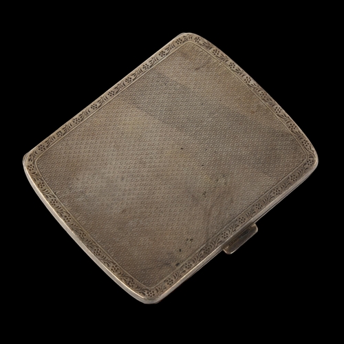 1566 - A George V silver cigarette case, curved rectangular form with allover engine turned decoration and ... 