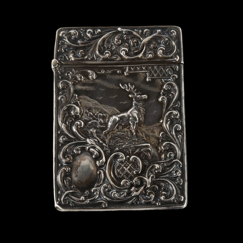 1570 - A George V silver 'Monarch of the Glen' castle-top card case, with allover relief embossed foliate d... 