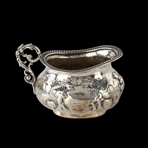 1574 - A Victorian silver cream jug, oval bulbous form with relief embossed village decoration and gadroone... 