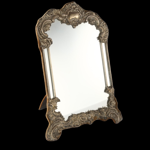 1579 - A large Edwardian silver-fronted dressing table mirror, with relief embossed foliate decoration and ... 