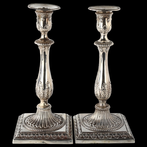 1601 - A pair of 18th century Neo-Classical silver table candlesticks, with relief embossed acanthus leaf d... 