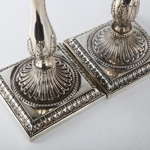 1601 - A pair of 18th century Neo-Classical silver table candlesticks, with relief embossed acanthus leaf d... 