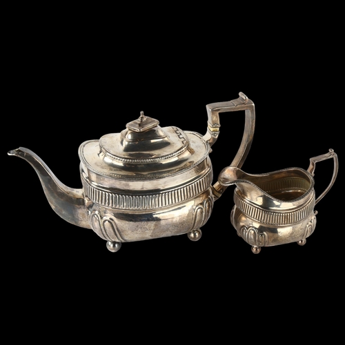 1610 - A George III silver teapot and cream jug set, oval bulbous form with half-fluted decoration, gadroon... 