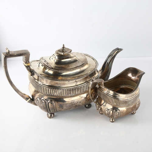 1610 - A George III silver teapot and cream jug set, oval bulbous form with half-fluted decoration, gadroon... 