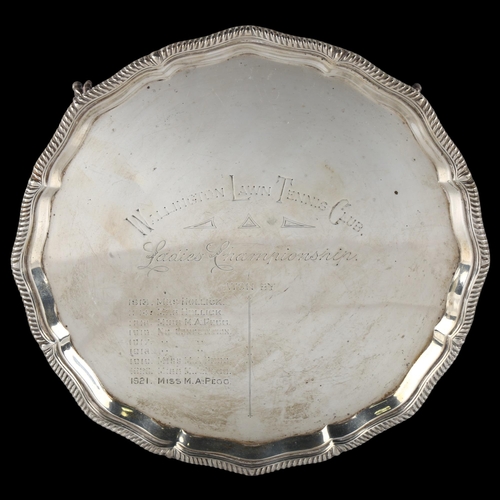 1614 - A George V silver presentation salver, circular form with scalloped and gadrooned rim, on claw and b... 