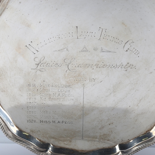 1614 - A George V silver presentation salver, circular form with scalloped and gadrooned rim, on claw and b... 