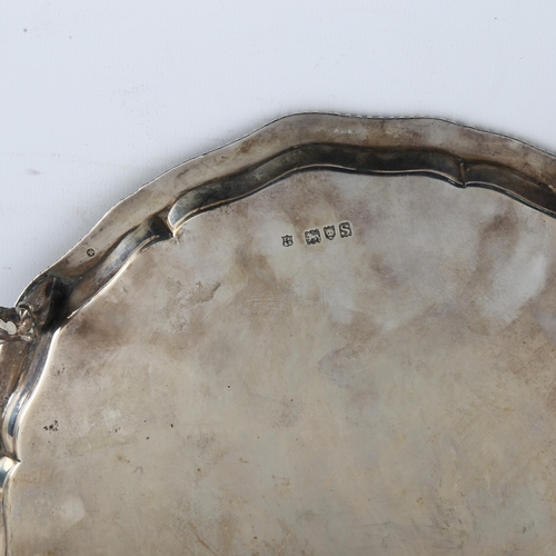 1614 - A George V silver presentation salver, circular form with scalloped and gadrooned rim, on claw and b... 