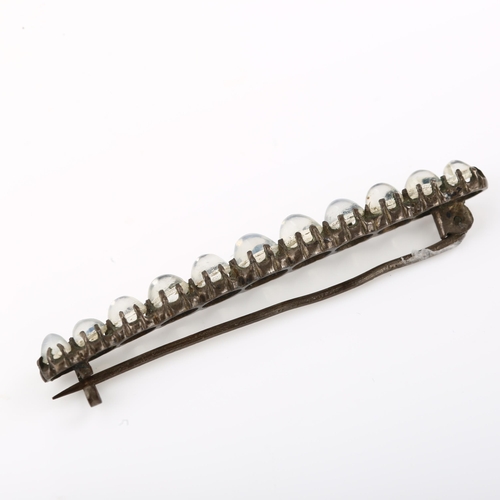 1388 - A 19th century graduated moonstone line bar brooch, unmarked silver settings, brooch length 53.9mm, ... 