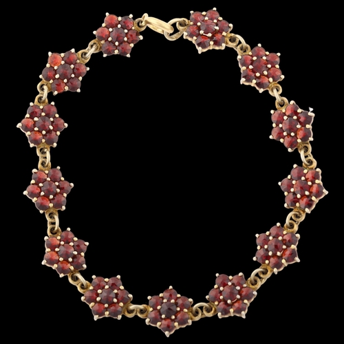 1392 - A Victorian Bohemian garnet flowerhead line bracelet, Continental 900 silver-gilt settings with face... 