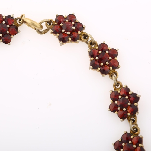 1392 - A Victorian Bohemian garnet flowerhead line bracelet, Continental 900 silver-gilt settings with face... 