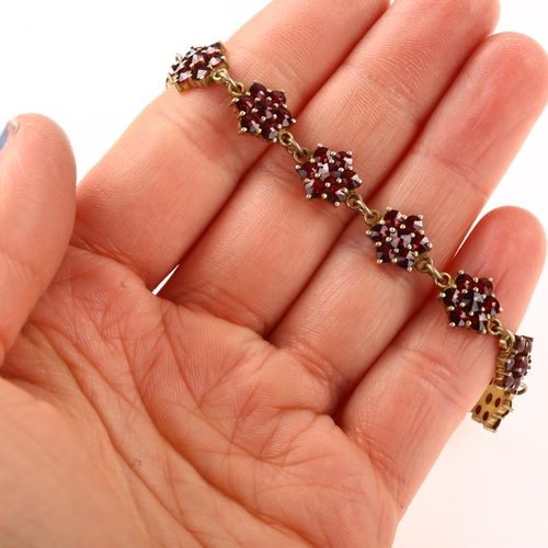 1392 - A Victorian Bohemian garnet flowerhead line bracelet, Continental 900 silver-gilt settings with face... 