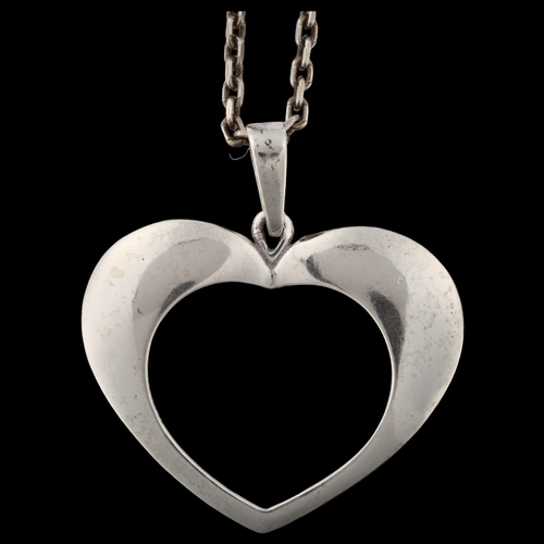 1394 - BERNHARD HERTZ - a Danish modernist sterling silver openwork heart pendant necklace, on silver cable... 