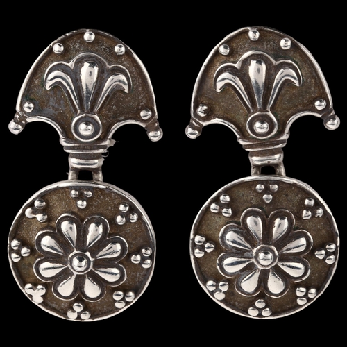 1404 - A pair of late 20th century silver drop earrings, with relief embossed decoration, maker's marks AJ,... 