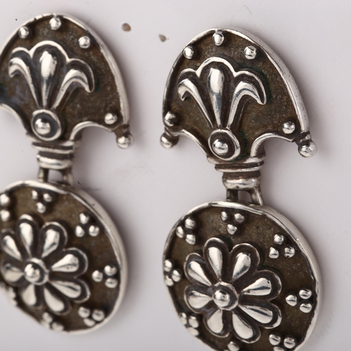 1404 - A pair of late 20th century silver drop earrings, with relief embossed decoration, maker's marks AJ,... 