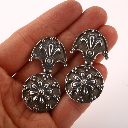 1404 - A pair of late 20th century silver drop earrings, with relief embossed decoration, maker's marks AJ,... 