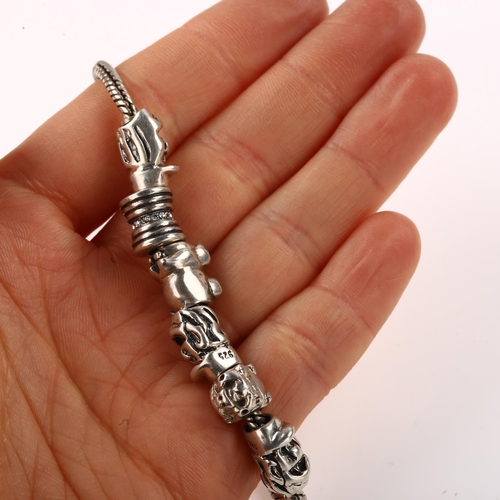 1410 - A silver snake link charm bracelet, with 6 silver charms, bracelet length 18cm, 29.1g